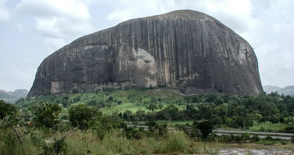 Zuma Rock rising above green countryside near Abuja